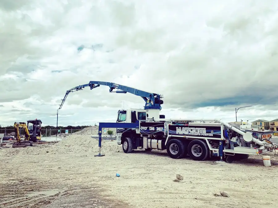 Natcrete boom pump set up on a new residential estate ready to pump a house slab